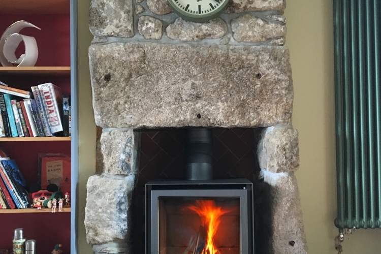 Stuv 16 cube in traditional stone fireplace