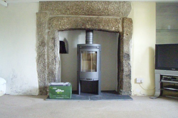 Contura 556 in traditional stone fireplace