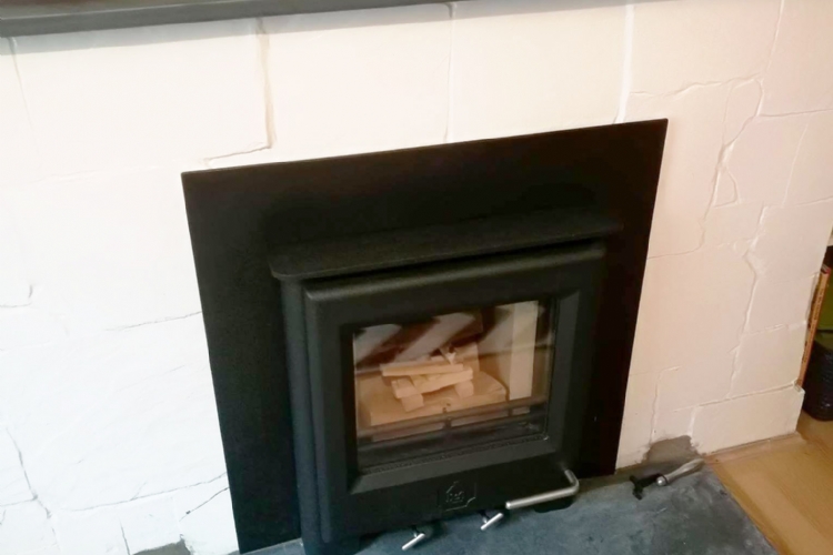 Woodwarm inset fire in brick