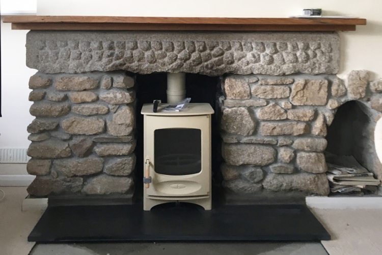 Charnwood C4 in a cosy stone fireplace