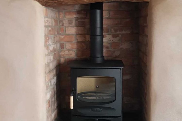 The Charnwood C range in a traditional fireplace