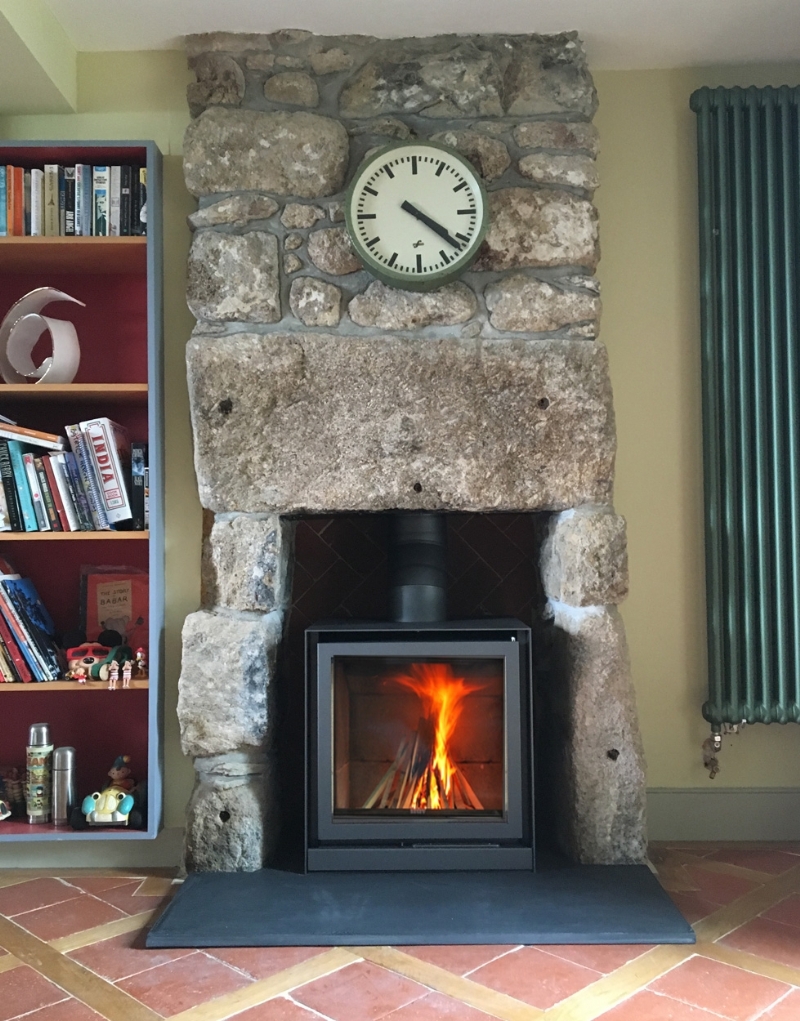 Stuv 16 cube in traditional stone fireplace