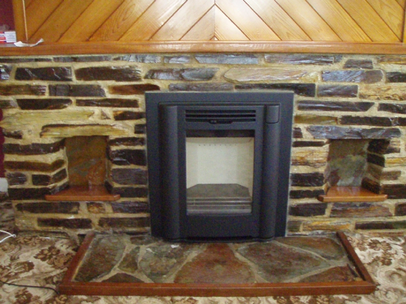 Contura I4classic in traditional stone fireplace