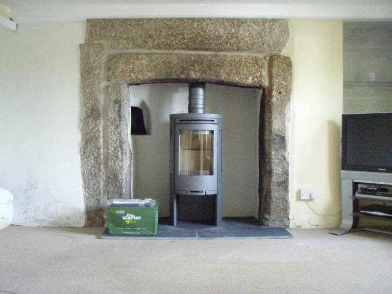 Contura 556 in traditional stone fireplace