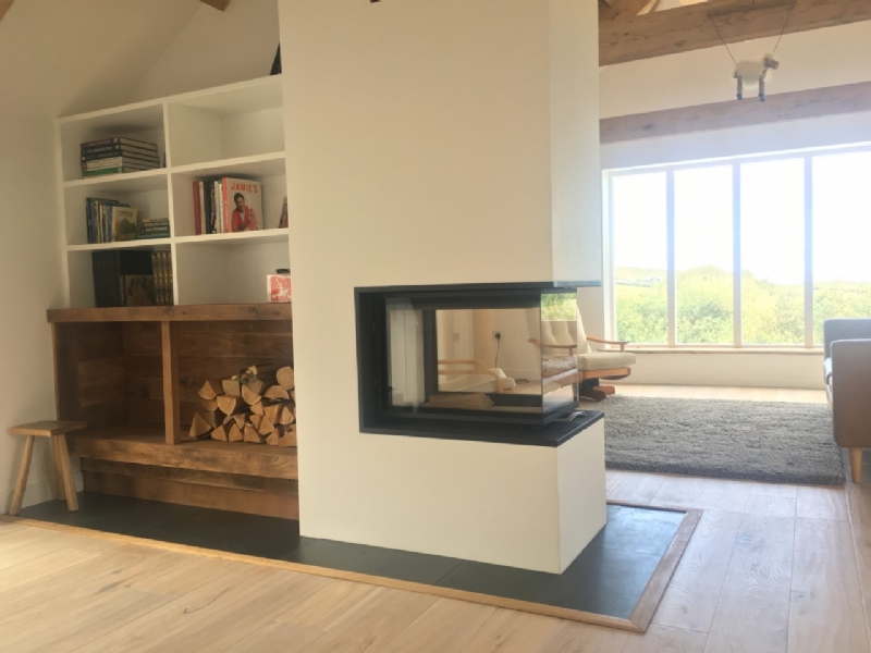 Three sided fireplace and feature wall